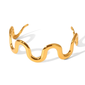 Polished 18K gold plated wavy bangle detail showing the glossy finish and open cuff style
