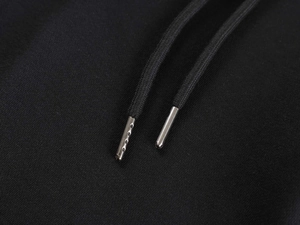 Detail of high-quality black cotton drawstring with polished silver metal aglets