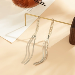 Detail of silver long tassel earrings with snake chains and woven texture design