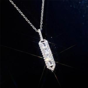 Luxury geometric necklace with rectangular baguette stones and halo crystals on black background