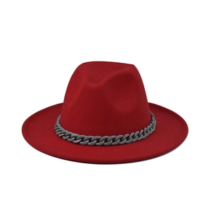 Close-up of red flat brim wool fedora hat featuring a grey chain decorative band