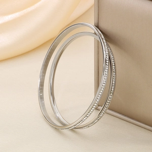 Detailed view of silver titanium steel bangles with sparkling pavé cubic zirconia inlay