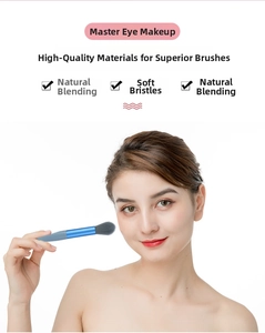 Detail of soft gray bristles and blue metallic handle on a portable blending eyeshadow brush