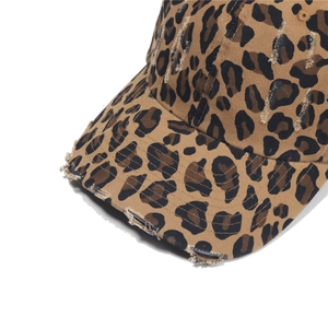 Detailed macro view of vintage leopard print canvas baseball cap with distressed brim