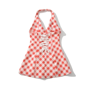 Red plaid halter neck dress with crisscross tie-back design on a white background