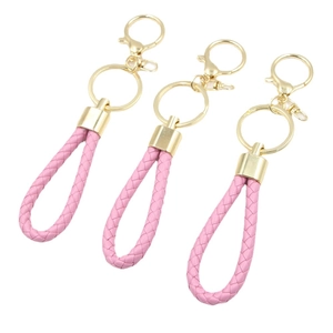 Set of three pink braided leather keychains with polished gold alloy clips on white background
