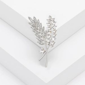 Detailed view of leaf brooch featuring silver metal and sparkling rhinestones