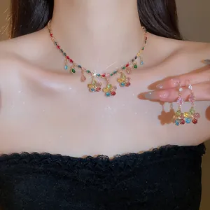 Detail of colorful zircon flower and teardrop tassel necklace and earring set on neck