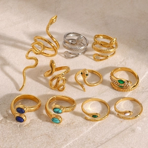 Flat lay of snake rings in gold and silver finish with turquoise and agate inlays