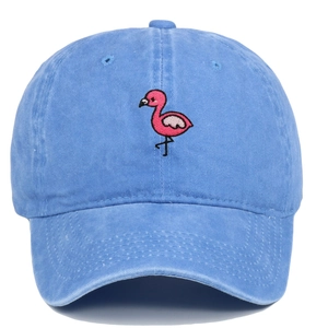 Close-up of pink flamingo embroidery on washed blue cotton baseball cap with ventilation holes