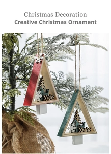 Detailed view of red and green triangular wooden Christmas ornaments on a pine tree branch