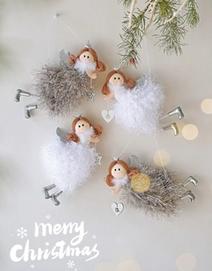 Detail of plush Christmas angel ornaments with silver wings and heart charms