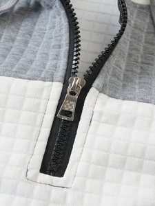 Close-up of the grey and white waffle texture fabric and silver metal zipper detail