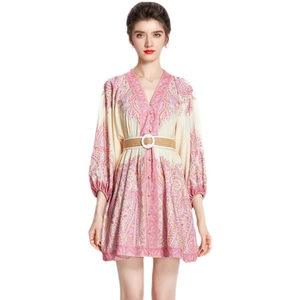 Bohemian floral V-neck mini dress with lantern sleeves and woven belt on model