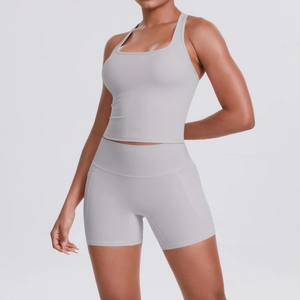 Detail of high-stretch light gray yoga set with racerback top and shorts with pockets