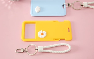Detail of slide-cover card holders with 3D cloud and flower decor and braided lanyards