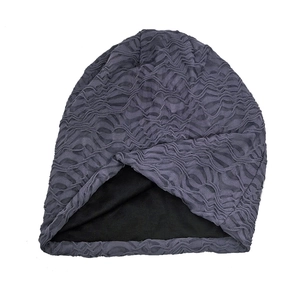 Detailed view of the dark grey double-layered slouchy beanie with pleated texture fabric