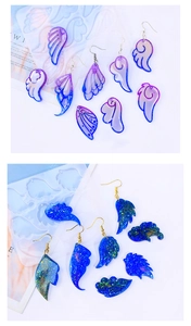 Macro detail of angel wing resin earrings showing translucent texture and glitter finish