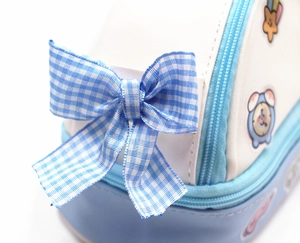 Détail du nœud à carreaux bleus et de la fermeture éclair d'une trousse à crayons mignonne