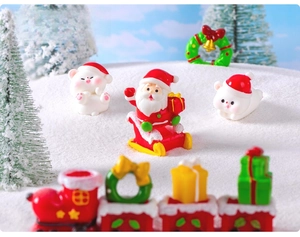 Miniature Christmas resin figurines with Santa on sleigh, polar bears and train in snow scene