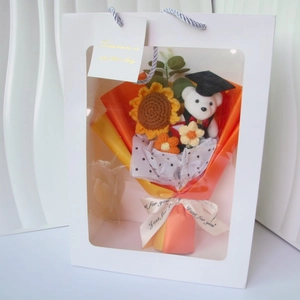 Knitted sunflower bouquet with graduation teddy bear in a white window gift bag