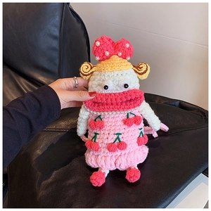 Detail of handmade crochet pink doll bag with cherry pattern and large red lips