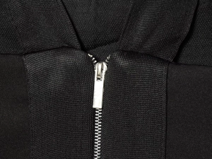 Detail of high-density black woven fabric with smooth silver metal zipper closure