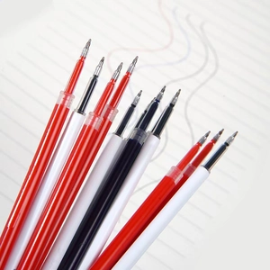 Macro shot of red and black neutral pen refills with metal bullet tips on lined paper