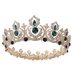 Vintage gold bridal crown with sparkling emerald crystals and rhinestones on white background