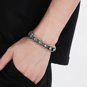 Close-up of men's retro skull chain bracelet in vintage silver finish on wrist