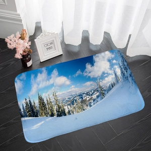 Detailed top view of snow mountain flannel floor mat on dark wood floor with home decor