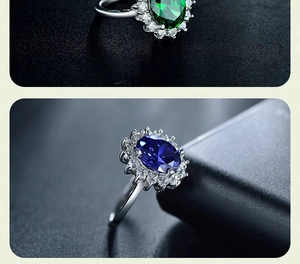 Detailed macro view of vintage silver rings with emerald and sapphire oval cut stones