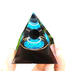 Handheld crystal pyramid energy ornament with black sphere and blue mandala base