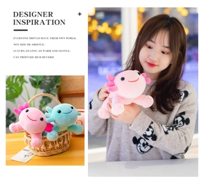 Pink and blue axolotl plush toys in a basket and held by a model in a lifestyle scene