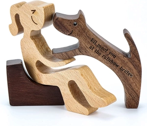 Detailed view of hand-carved wooden dog figurine with Rainbow Bridge memorial engraving