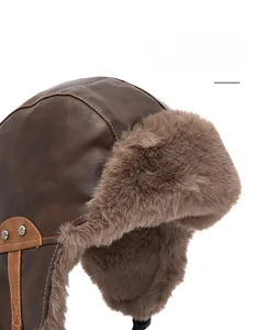 Detailed view of the thick plush faux fur lining on the brown leather pilot trapper hat