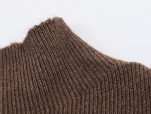 Detailed macro view of dark brown rib-knit texture on a high neck knit sweater