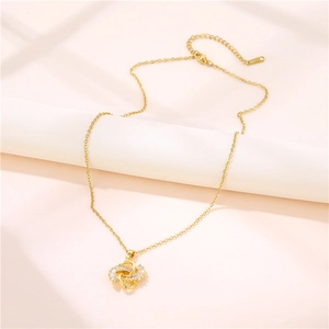 Elegant 18K gold knot pendant necklace with sparkling cubic zirconia on a minimalist O-chain