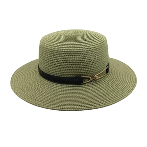 Detail of sage green flat top straw hat showing fine weave texture and metal buckle strap