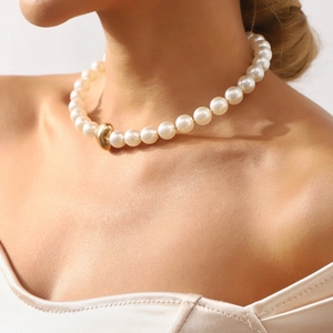 Elegant vintage pearl choker necklace with a gold heart pendant for women