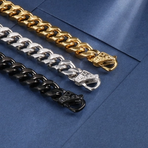 Detailed view of Cuban chain bracelets in gold, silver and black with lobster clasps