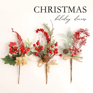 Three festive Christmas berry picks with pine cones, stars and bells on white background