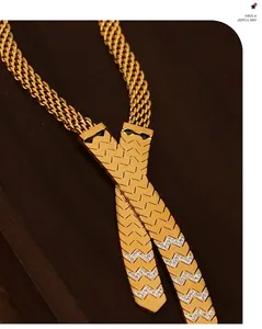 Macro detail of 18K gold plated cross pendant necklace with micro-set zircons on wood