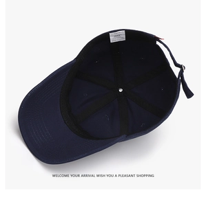 Detail view of cotton baseball cap interior with adjustable metal buckle and brand label