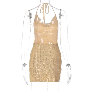 Detail of gold halter top and sequined mini skirt on transparent mannequin for party
