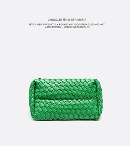 Detail of green woven clutch bag showing wide leather texture and minimalist style