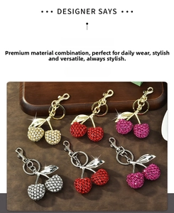 Detail of crystal-encrusted cherry keychains in multiple vibrant color combinations