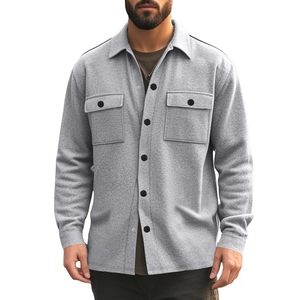Detail of light gray men's fleece jacket with black buttons and flap chest pockets
