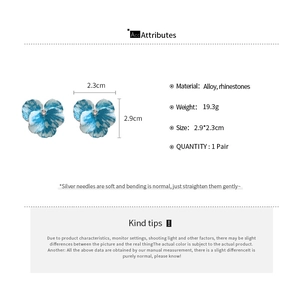 Detailed view of blue flower earrings with rhinestone accents and size specifications