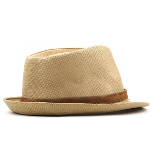 Detail view of woven straw fedora hat featuring a stylish brown suede band